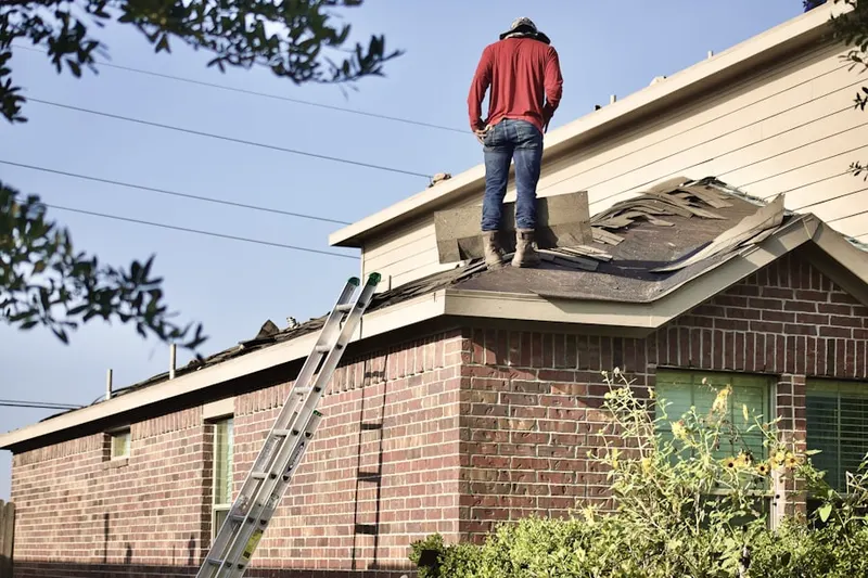 Professional roofer working on a residential roof in Sally Ann
